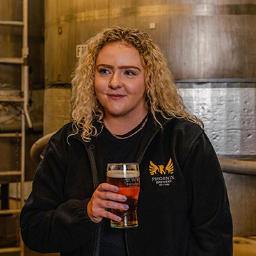 Phoenix Brewery team member Lucy enjoying a pint of Phoenix Brewery beer