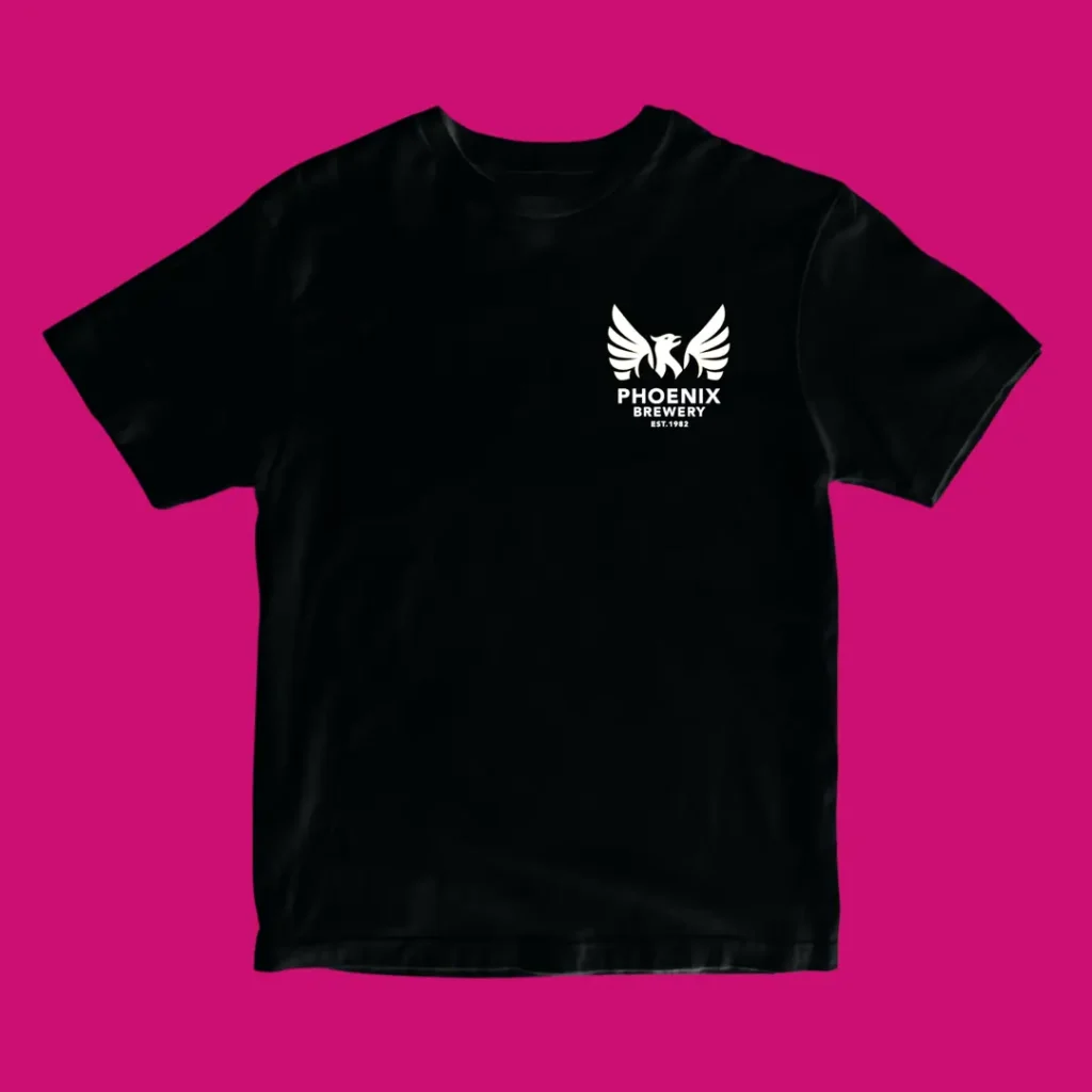 Black Phoenix Brewery t-shirt front with small white phoenix chest logo on a pink background